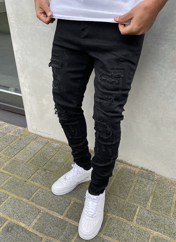 Zerrissene und reparierte Jeans – Schwarz