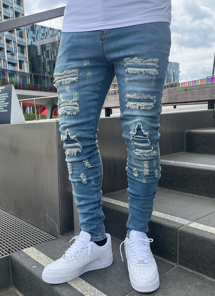 Zerrissene und reparierte Jeans – Hellblau